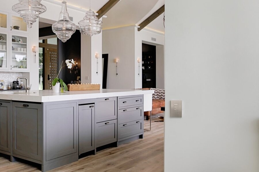 A kitchen living space illuminated by Lutron fixtures